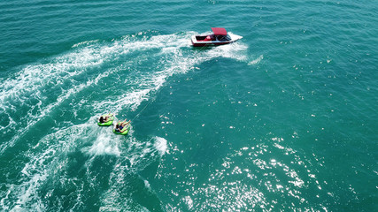 Obraz premium Aerial drone photo of extreme powerboat donut watersports crusing in high speed in tropical turquoise bay