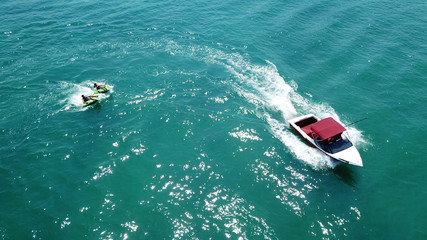 Aerial drone photo of extreme powerboat donut watersports crusing in high speed in tropical turquoise bay