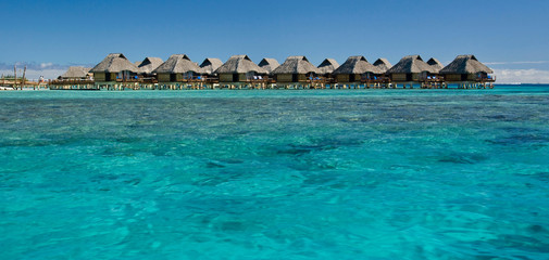 French Polynesia, Bora Bora. Over-water bungalows with grass thatched roofs.
