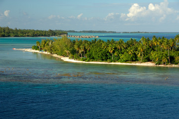 French Polynesia, Bora Bora. Teavanui Pass, only access through reef . Pearl Beach Resort located on tiny reef island in distance.