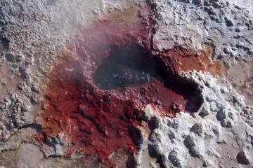 Detail of a hot spring spewing chemical rich water from the earth creating the colors and textures seen in this earth surface image.