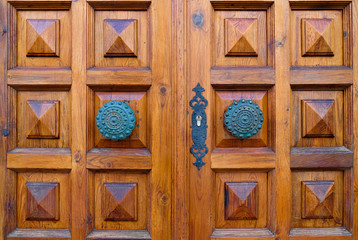Very elegant decorative wooden door and ornamental bronze door knobs.