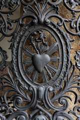 Brazil, Rio de Janeiro. Detailed shot of sacred heart on fence of Saint Benedict Monastery.