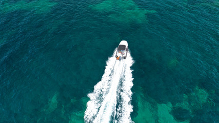 Aerial top view luxury inflatable rib speed boat cruising in Mediterranean emerald sea