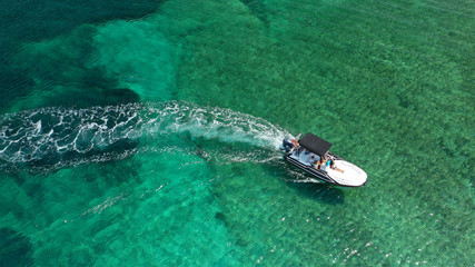 Aerial top view luxury inflatable rib speed boat cruising in Mediterranean emerald sea