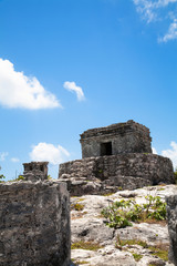 Cancun, Quintana Roo, Mexico - Low angle view of an ancient stone structure on the top of a hill.