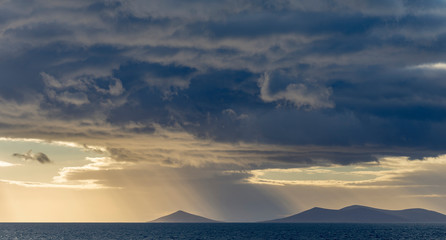 The islands of the West Falklands seen from the sea with dramatic clouds. Saunders Island, Keppel Island and Pebble Island.