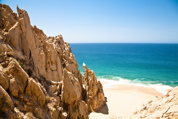 Fototapeta na wymiar Cabo San Lucas, Baja California Sur, Mexico - A beach with a large rock formation.