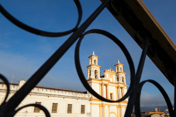 Mexico, San Cristobal de las Casas. A colonial church is seen through a wrought-iron railing.