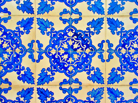 Decorative ornamental blue tiles (Portuguese azulejos), a graphic element of Portuguese history and culture, close up detailed view.
