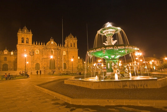 South America - Peru. Night shot of Plaza de Armas with fountain and La Catedral in Cusco.
