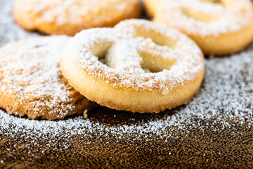 cookies with icing sugar and wood background