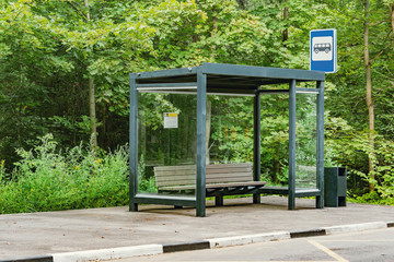 Empty bus stop in the summer forest.
