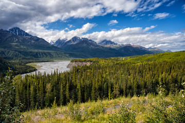 Glacial water melt river in valley in mountain range in Alaska