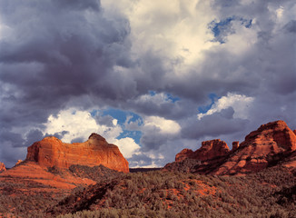 USA, Arizona, Oak Creek Canyon. Dramatic storm clouds gather behind the red rocks of Oak Creek Canyon, near Sedona, in Arizona.