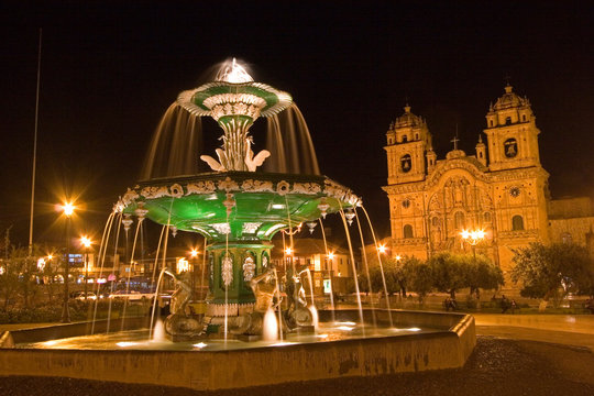 South America - Peru. Night shot of Plaza de Armas with fountain and La Compania in Cusco.