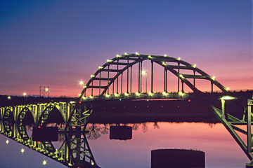 USA, Arkansas, Ozark. View of the Ozark Bridge across the Arkansas River at twilight. 