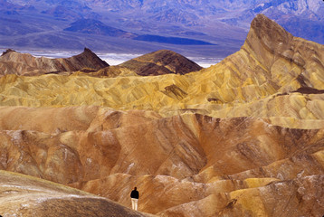 Fototapeta na wymiar California: Death Valley Naitonal Park, view from Zabriskie Point with tourist enjoying overlook, January.