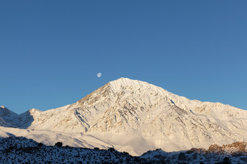 USA, California, Sierra Nevada Mountains. Moonset behind Mt. Tom. 