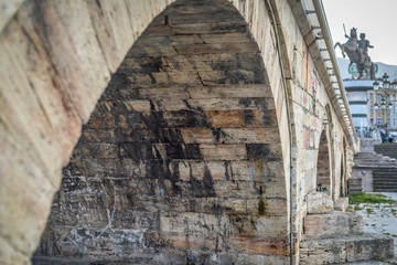 Skopje,Stone Bridge, low angle,towards steps with statue of warrior on horse in background.