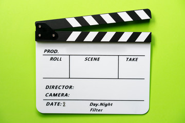 movie clapper on green table background ; film, cinema and video photography concept
