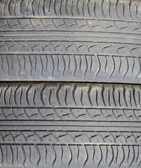 The background of the tread pattern of the car wheel. Rubber tir