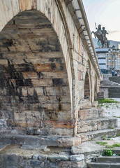 Skopje,Stone Bridge, low angle,towards steps with statue of warrior on horse in background.