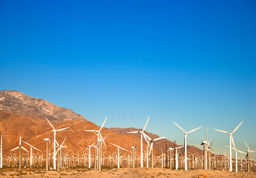 Palm Springs, CA, USA. Wind turbine farm in the desert under a clear blue sky.