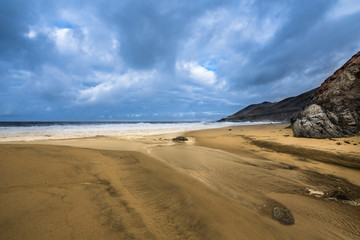 Stream of water making its way into the Pacific Ocean of Garrapata Beach, California