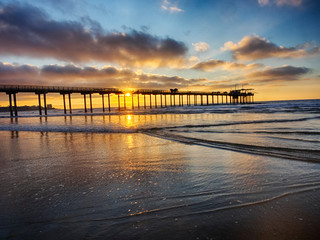 Scripps Institution of Oceanography Pier with sunset and bright clouds