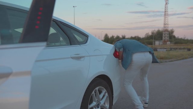 Young Male Driver Suffering From Motion Sickness Stopping His Car. Portrait Of Hurrying Man Running Out Of Car Diving In Its Back.