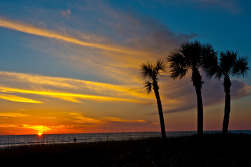 USA, Florida, Sarasota. Crescent Beach. Cloud streaked yellow-orange Siesta Key sunset