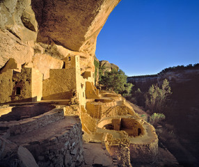 USA, Colorado, Mesa Verde NP. Sunset light paints the Anasazi village at Cliff Palace, Mesa Verde...