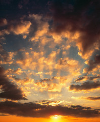 USA, California, Mojave Desert. The rising sun peaks from under clouds in the Mojave Desert in southern California.