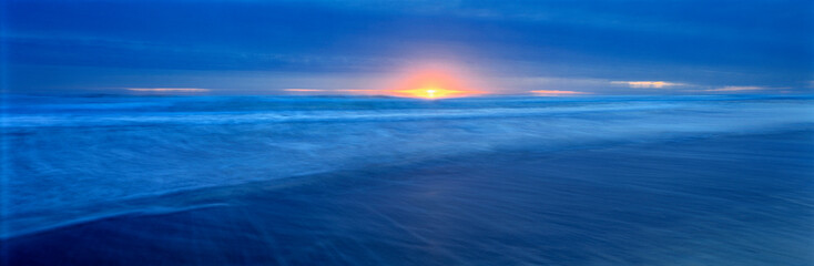 USA, California, Del Norte Co. The sun glints through storm clouds on the Del Norte coast in...