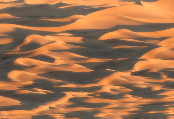 Abstract sand dunes of Death Valley glowing in sunset light
