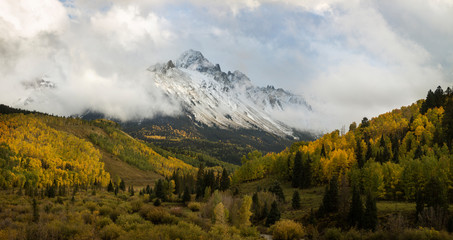 USA, Colorado, Sneffels Range. Snow clouds over mountain landscape at sunset. 