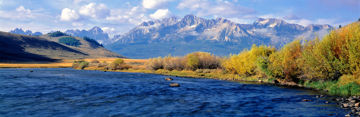 USA, Idaho, Sawtooth NRA. The Salmon River courses wide and azure before the rugged Sawtooth range...