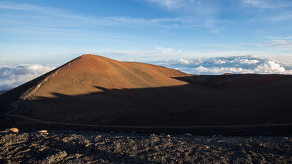 Direct sunlight shines on one of the hills at the top of Mauna Kea on the Big Island of Hawaii.