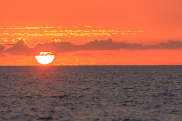 Sun setting on ocean off Maui, Hawaii, USA