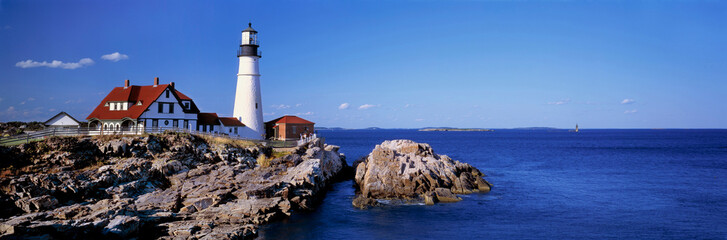 USA, Maine, Portland Head Light. The white-washed Portland Head Lighthouse, in Maine, is contrasted...