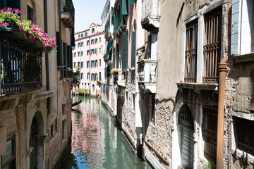 Fototapeta na wymiar Narrow Canal And Old Historic Houses In Venice