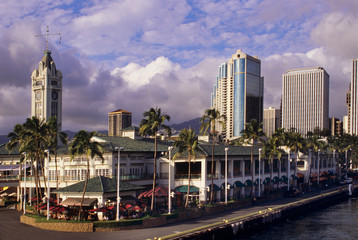 Fototapeta na wymiar Famed Aloha Tower dominates the scene at Honolulu harbor.