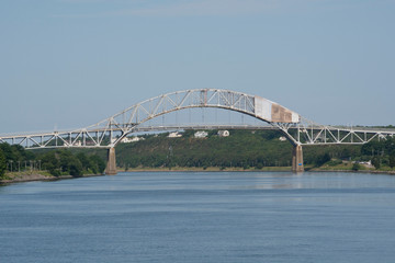 Fototapeta premium Massachusetts, Cape Cod, Atlantic Intracoastal Waterway. Cape Cod Canal, artificial waterway connecting Cape Cod Bay in the north to Buzzards Bay in the south. Sagamore Bridge.