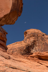 USA, Nevada, Clark County, Valley of Fire State Park. Atlatl Rock area with moon framed between rock formations.