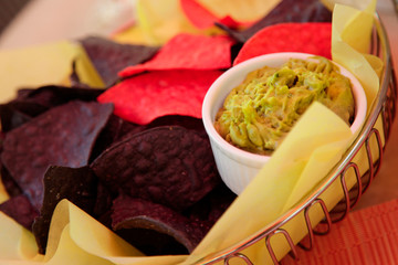 Santa Fe, New Mexico, United States. Blue and red corn chips with guacamole.