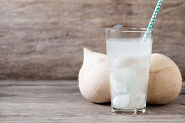 Fresh coconut juice in a glass with coconut white meat isolated on white