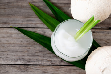 Fresh coconut juice in a glass with coconut white meat isolated on white