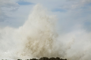 USA, Oregon, Cape Perpetua. Large wave crashes into rocky headland. 