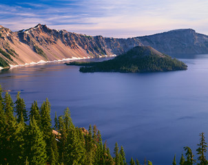 USA, Oregon, Crater Lake National Park. West rim of Crater Lake with Hillman Peak (center) and Llao Rock (right) above Wizard Island.